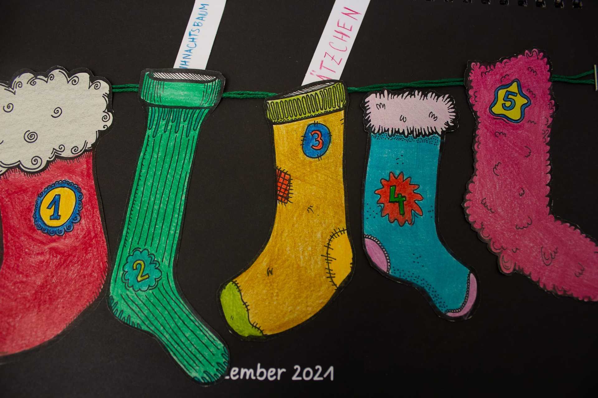 Detailansicht der fertigen Kalenderseite. Bunte Buchstaben und ein handgeschriebenes Gedicht