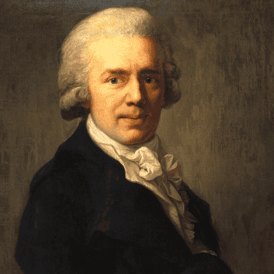 Christian Gottfried Körner hat hellgraues, gewelltes Haar. Er trägt ein Hemd mit Rüschen und eine blaue Jacke.